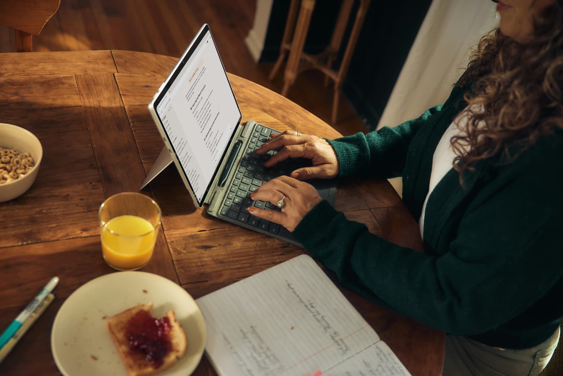 Professional working on a tablet at a bright table
